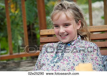 Young blonde girl smiling at the camera View Large Photo Image Stock Image - Young blonde girl smiling at the camera. Fotosearch