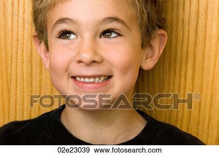 Young boy with mischievous smile. View Large Photo Image Stock Photo - Young boy with mischievous smile.. Fotosearch