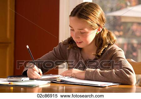 Young girl doing homework at kitchen table. View Large Photo Image Stock Photography - Young girl doing homework at kitchen table.. Fotosearch