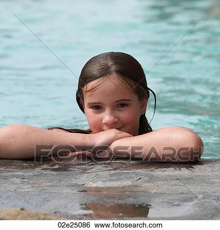 Young girl leaning on the side of the pool. View Large Photo Image Stock Photograph - Young girl leaning on the side of the pool. . Fotosearch