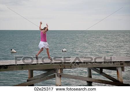 Young girl on a pier at Placencia in Belize View Large Photo Image Stock Photo - Young girl on a pier at Placencia in Belize. Fotosearch