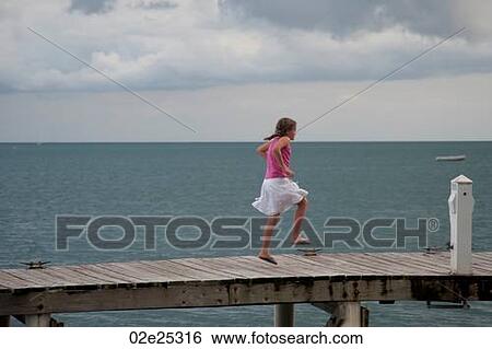 Young girl on a pier at Placencia in Belize View Large Photo Image Stock Photograph - Young girl on a pier at Placencia in Belize. Fotosearch
