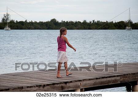 Young girl on a pier at Placencia in Belize View Large Photo Image Stock Photography - Young girl on a pier at Placencia in Belize. Fotosearch