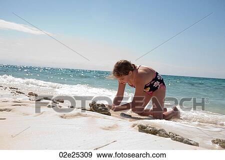 Young girl playing in the sand on Belizean Isle in Belize View Large Photo Image Stock Photo - Young girl playing in the sand on Belizean Isle in Belize. Fotosearch