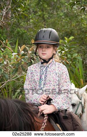 Young girl riding a horse at Mountain Pine Ridge Reserve in Belize View Large Photo Image Stock Photo - Young girl riding a horse at Mountain Pine Ridge Reserve in Belize. Fotosearch