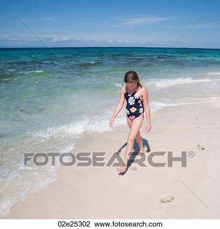 Young girl walking along beach at Belizean Isle in Belize View Large Photo Image Stock Image - Young girl walking along beach at Belizean Isle in Belize. Fotosearch