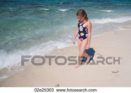 Young girl walking along beach at Belizean Isle in Belize View Large Photo Image Stock Image - Young girl walking along beach at Belizean Isle in Belize. Fotosearch