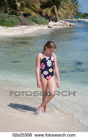 Young girl walking along beach at Belizean Isle in Belize View Large Photo Image Stock Photograph - Young girl walking along beach at Belizean Isle in Belize. Fotosearch