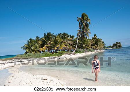 Young girl walking along beach at Belizean Isle in Belize View Large Photo Image Stock Photography - Young girl walking along beach at Belizean Isle in Belize. Fotosearch