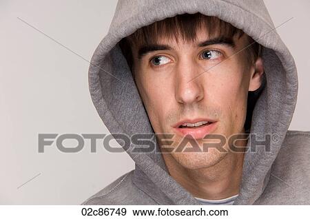 Stock Photo - Young male wearing hooded sweatshirt.. Fotosearch