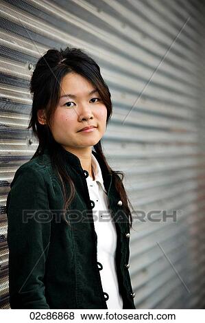 Young serious Asian girl. View Large Photo Image Stock Photo - Young serious Asian girl.. Fotosearch