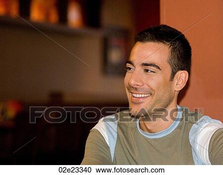 Young smiling man in pub. View Large Photo Image Stock Image - Young smiling man in pub.. Fotosearch