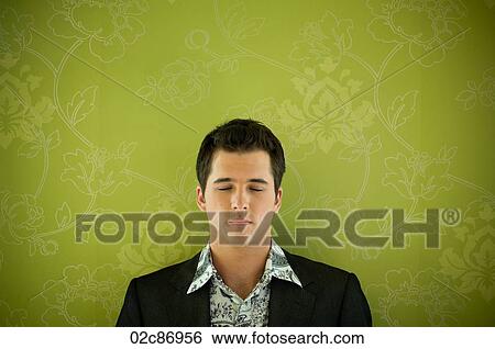 Stock Photograph - Young urban business man with eyes closed.. Fotosearch