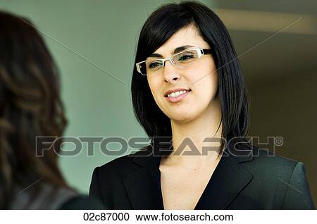 Young urban businesswoman engaged in conversation. View Large Photo Image Stock Image - Young urban businesswoman engaged in conversation.. Fotosearch