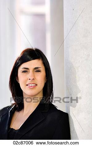 Young urban businesswoman leaning against pillar. View Large Photo Image Stock Photograph - Young urban businesswoman leaning against pillar.. Fotosearch