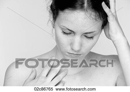 Stock Photography - Young woman with bare shoulders in deep reflective thought.. Fotosearch