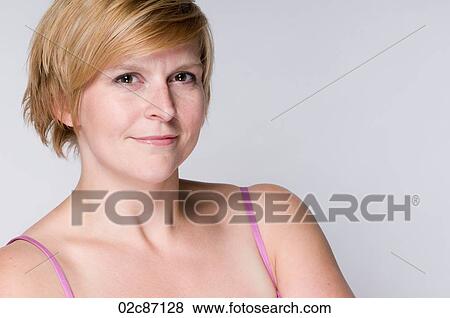 Stock Photo - Young woman with crossed arms smiling.. Fotosearch