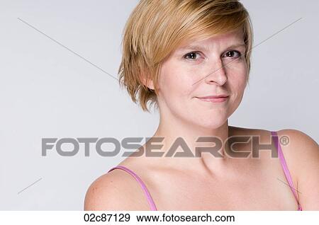 Young woman with crossed arms smiling. View Large Photo Image Stock Photo - Young woman with crossed arms smiling.. Fotosearch