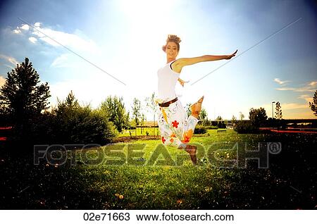 A retro style photograph of a woman dancing in a garden View Large Photo Image Stock Image - A retro style photograph of a woman dancing in a garden. Fotosearch