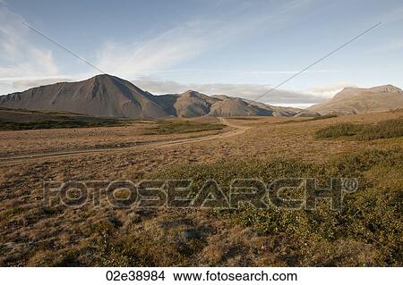 Picture - Arid landscape of grasslands and mountains. Fotosearch