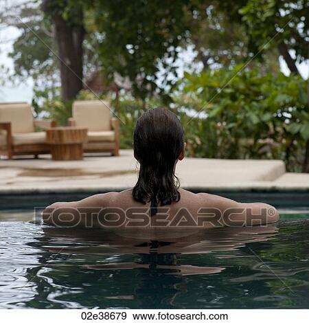 Back view of a brunette woman in a pool in Costa Rica View Large Photo Image Stock Photo - Back view of a brunette woman in a pool in Costa Rica. Fotosearch