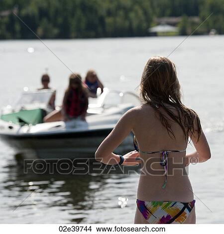 Picture - Back view of a girl in a bikini at Lake of the Woods, Ontario. Fotosearch