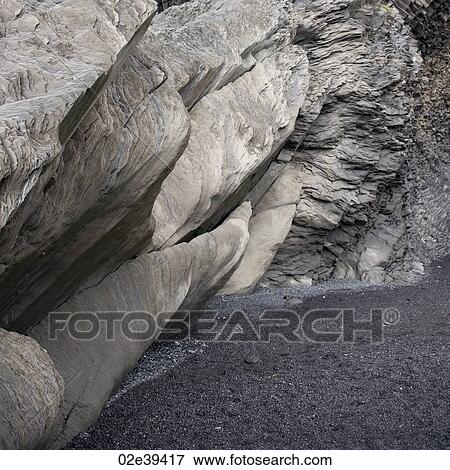 Basalt rock formation cave over sand View Large Photo Image Stock Photo - Basalt rock formation cave over sand. Fotosearch