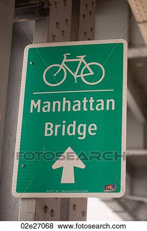 Stock Photo - Bicycle lane direction sign to the Manhattan Bridge in Manhattan, New York City, U. S. A.. Fotosearch