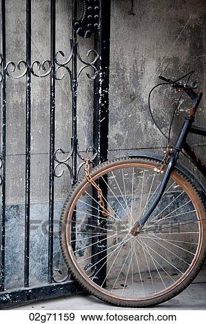 Bicycle locked at a gate, Shanghai, China View Large Photo Image Stock Photo - Bicycle locked at a gate, Shanghai, China. Fotosearch