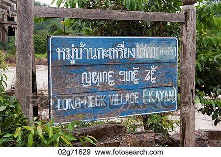 Stock Photo - Bilingual signboard of Long Neck Village, Huay Pu Keng, Mae Hong Son Province, Thailand. Fotosearch