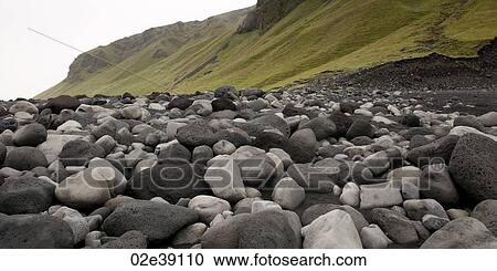 Black and white rocks on the beach, next to grassy slope View Large Photo Image Stock Image - Black and white rocks on the beach, next to grassy slope. Fotosearch