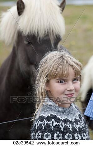 Blond girl standing in front of an Icelandic horse View Large Photo Image Stock Image - Blond girl standing in front of an Icelandic horse. Fotosearch