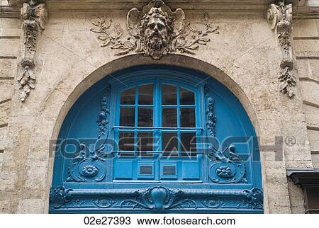 Stock Image - Blue arched exterior of a building in Paris France. Fotosearch