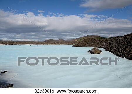 Blue lagoon with rocky coastline under a bright blue clouded sky View Large Photo Image Stock Photography - Blue lagoon with rocky coastline under a bright blue clouded sky. Fotosearch