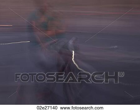Blurred image of a person riding a bike in Paris France View Large Photo Image Stock Image - Blurred image of a person riding a bike in Paris France. Fotosearch