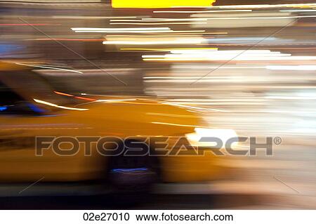 Blurred image of a yellow taxi in Manhattan, New York City, U. S. A. View Large Photo Image Stock Image - Blurred image of a yellow taxi in Manhattan, New York City, U. S. A.. Fotosearch