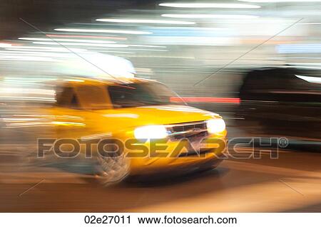 Blurred image of a yellow taxi in Manhattan, New York City, U. S. A. View Large Photo Image Stock Image - Blurred image of a yellow taxi in Manhattan, New York City, U. S. A.. Fotosearch