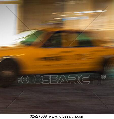 Blurred image of a yellow taxi in Manhattan, New York City, U. S. A. View Large Photo Image Stock Photo - Blurred image of a yellow taxi in Manhattan, New York City, U. S. A.. Fotosearch