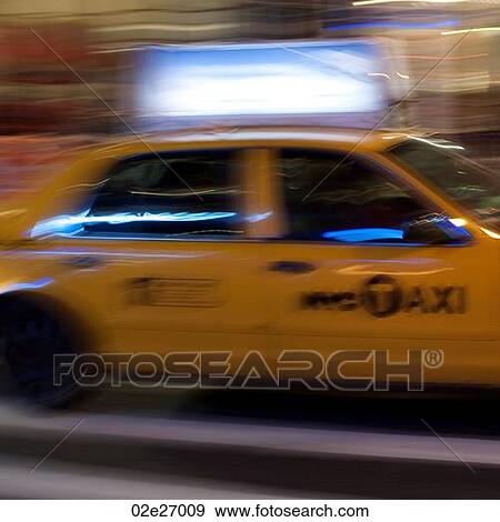 Blurred image of a yellow taxi in Manhattan, New York City, U. S. A. View Large Photo Image Stock Photo - Blurred image of a yellow taxi in Manhattan, New York City, U. S. A.. Fotosearch