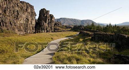 Stock Image - Boardwalk hiking trail through rugged canyon. Fotosearch