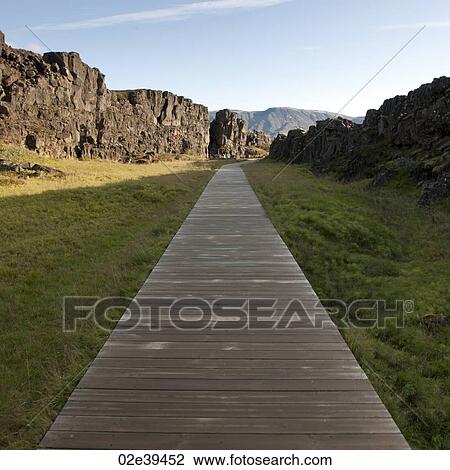 Boardwalk through grassland next to steep cliff View Large Photo Image Stock Image - Boardwalk through grassland next to steep cliff. Fotosearch