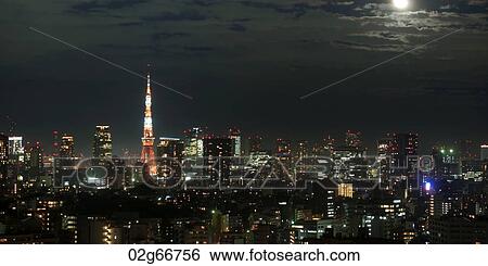 Buildings lit up at night in a city with Tokyo Tower in the background, Tokyo, Japan View Large Photo Image Stock Photograph - Buildings lit up at night in a city with Tokyo Tower in the background, Tokyo, Japan. Fotosearch