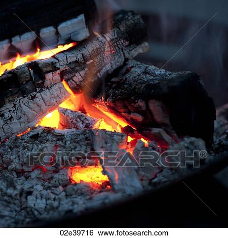 Stock Photograph - Burning embers of a campfire at Lake of the Woods, Ontario. Fotosearch