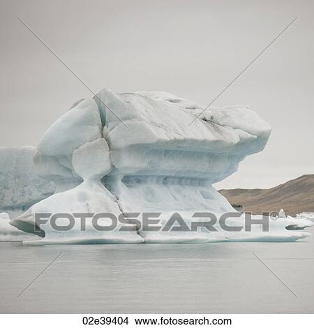 Picture - Calving iceberg floating in glacial lake. Fotosearch
