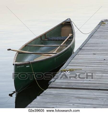 Canoe by a dock in Lake of the Woods, Ontario View Large Photo Image Stock Photography - Canoe by a dock in Lake of the Woods, Ontario. Fotosearch