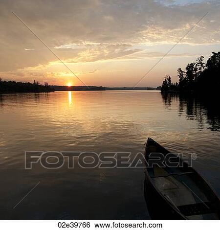 Canoe floating on the water at Lake of the Woods, Ontario View Large Photo Image Stock Photograph - Canoe floating on the water at Lake of the Woods, Ontario. Fotosearch