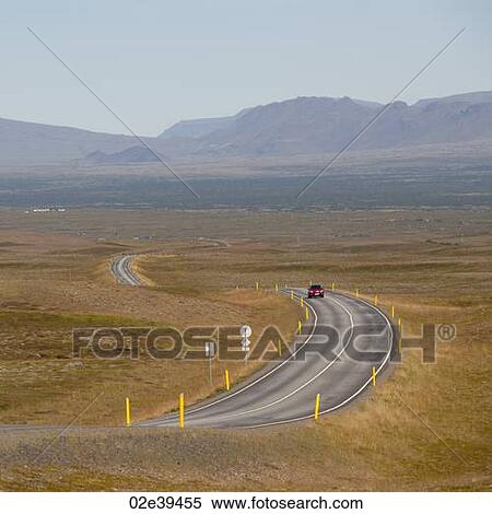 Car on meandering highway through countryside towards distant mountains View Large Photo Image Stock Photography - Car on meandering highway through countryside towards distant mountains. Fotosearch