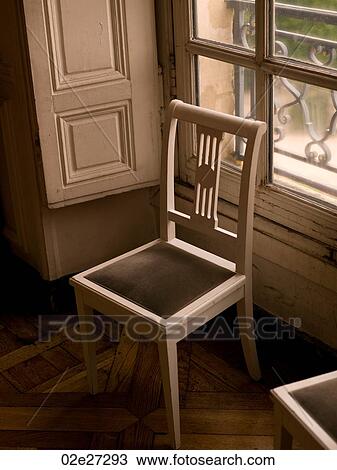 Stock Image - Chair in front of window. Fotosearch