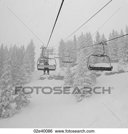 Stock Photograph - Chairlift on a ski slope in Vail, Colorado. Fotosearch