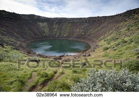 Circular pool of water in a volcanic crater with green vegetation surrounding View Large Photo Image Picture - Circular pool of water in a volcanic crater with green vegetation surrounding. Fotosearch